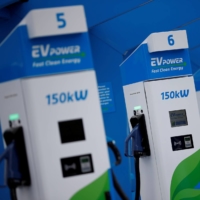 Electric vehicle charging units at a service station in Manchester, England | REUTERS 